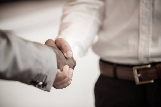 istock Handshake between african and a caucasian man 638600634