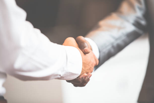 istock Handshake between african and a caucasian man 638600670