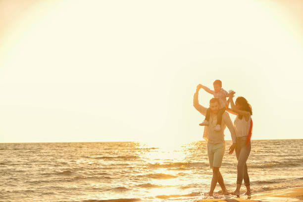 istock happy young family have fun on beach 638600874
