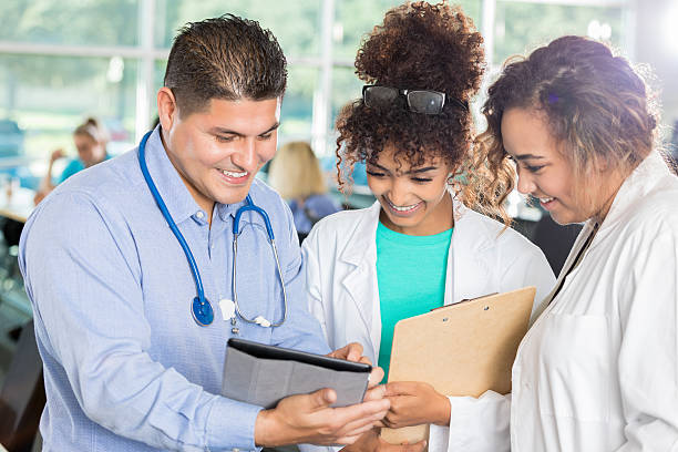 istock Team of doctors review patient's chart 638602254