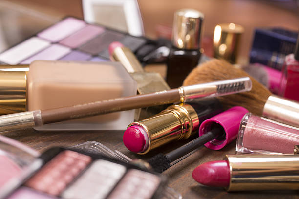 istock Pile of various cosmetics, make-up lie on wooden dressing table. 638602418