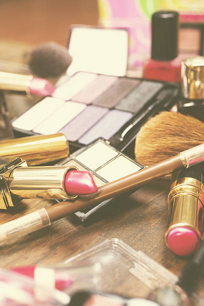 istock Pile of various cosmetics, make-up lie on wooden dressing table. 638603004
