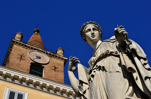 Pagan goddess statue and Christian church bell tower from People's Square in Rome