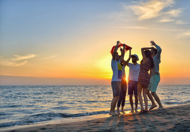 istock group of young people dancing at the beach 638603806
