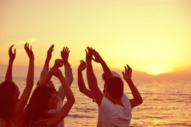 istock group of young people dancing at the beach 638603840