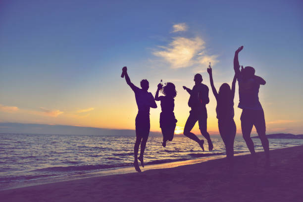istock group of young people dancing at the beach 638603936