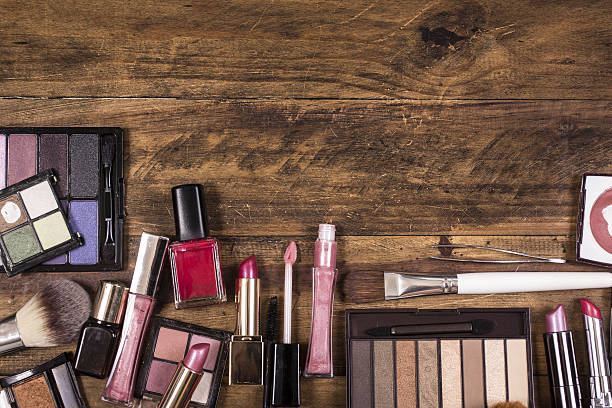Abundance of various professional cosmetics products on a white background- acetone, eye shadows, mascara, eyeliner, face powder, lipstick, moisturizer, nail polish, hand cream, brush.