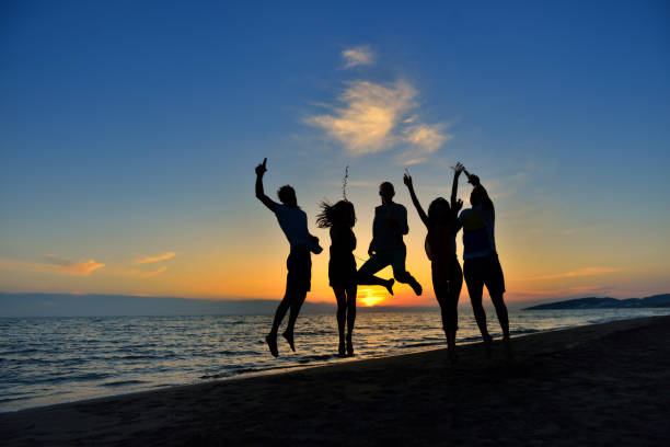 istock group of young people dancing at the beach 638603970