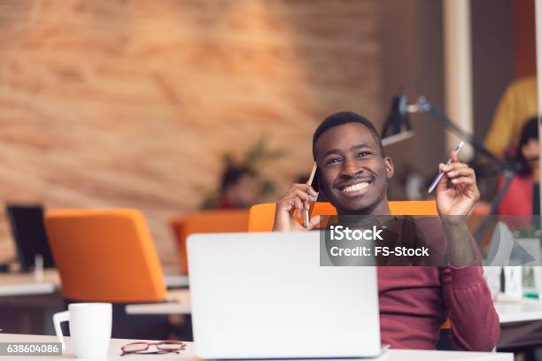 African American Businessman Sitting At The Computer In Startup Office Stock Photo - Download Image Now