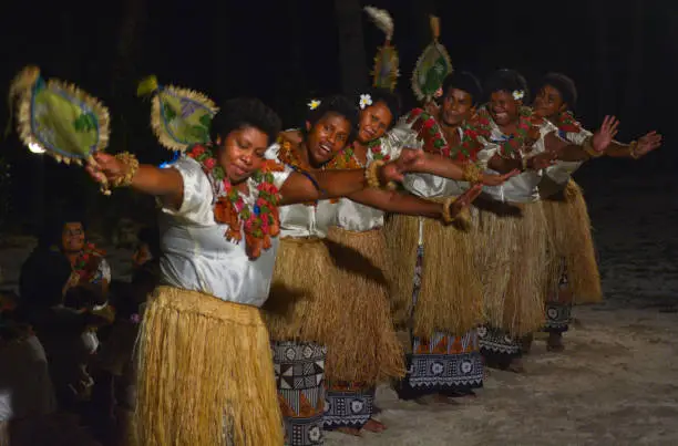 Fijian women dancing a traditional female dance Meke the fan dance. Real people copy space