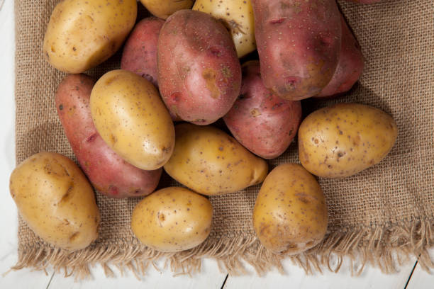 istock Potatoes on a white wooden background 638611030