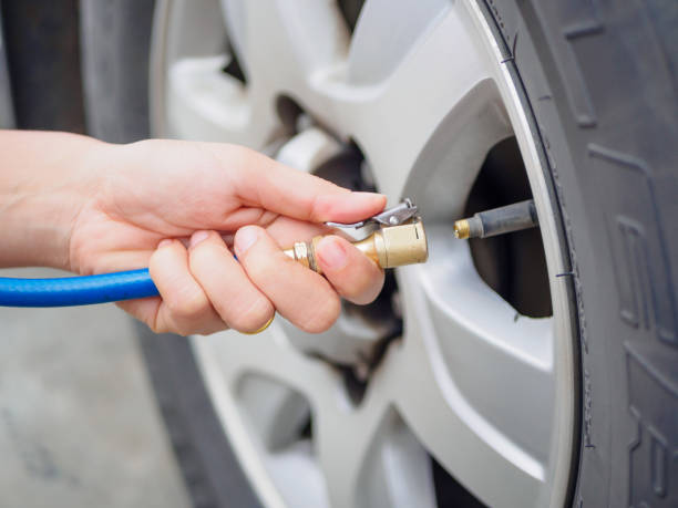 driver checking air pressure driver checking air pressure and filling air in the tires close up inflating photos stock pictures, royalty-free photos & images