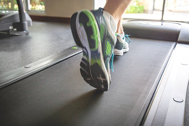 istock Adult man jogging on treadmill 638618342