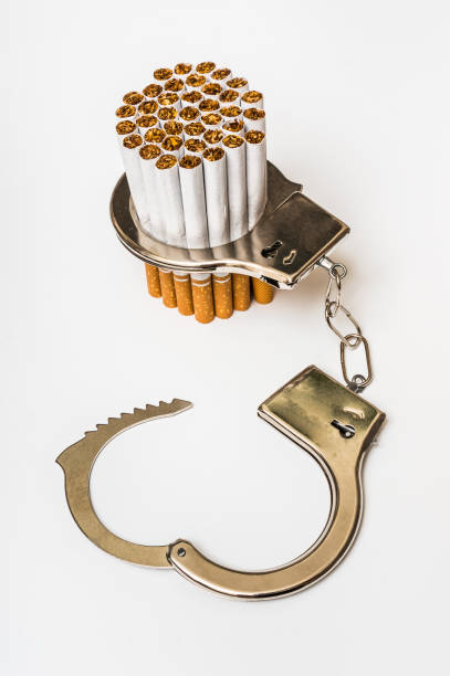 istock Cigarettes and handcuffs - smoking addiction concept 638618652