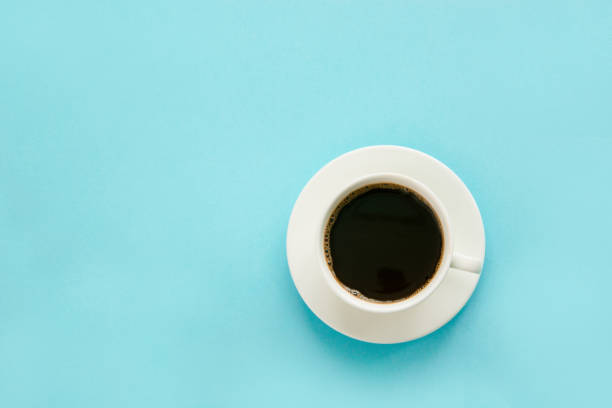istock Cup of black coffee on blue background. Isolated. Top view. 638620382