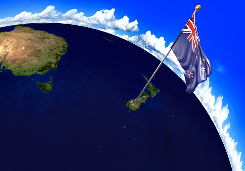 3D render of the national flag of New Zealand over the geographic location of the country on a world map. Parts of this image furnished by NASA.