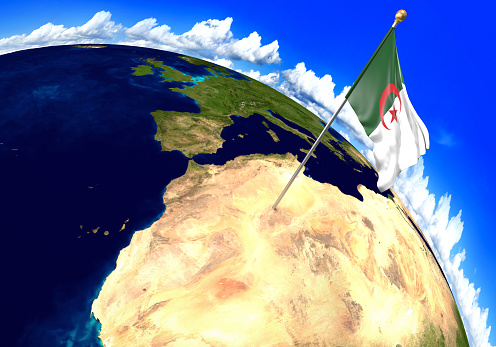 3D render of the national flag of Algeria over the geographic location of the country on a world map. Parts of this image furnished by NASA.