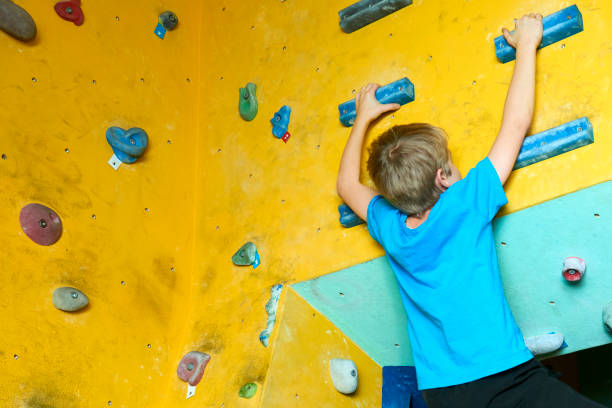 istock Free climber child young boy practicing on artificial boulders 638623620