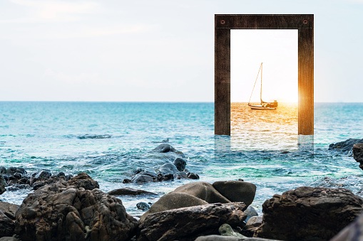 Seascape with wooden frame with sailboat and sunset