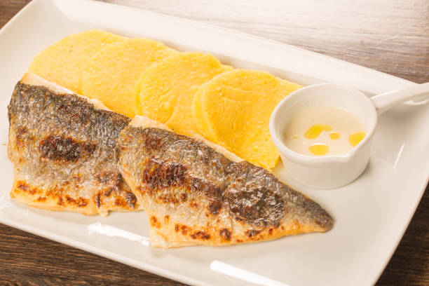 istock Grilled fish fillet with polenta on a white plate 638623740