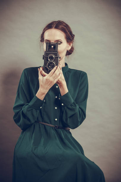 istock Woman retro style with old camera 638624456