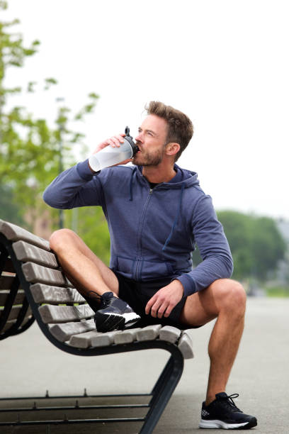 istock Jogger sitting on bench with water bottle 638626660