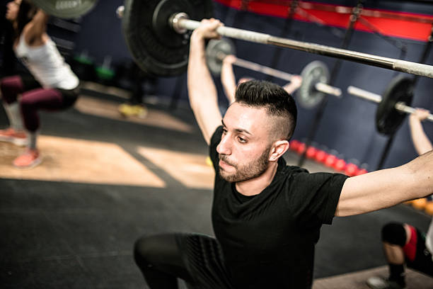 istock strong woman weightlifting a barbell 638626800