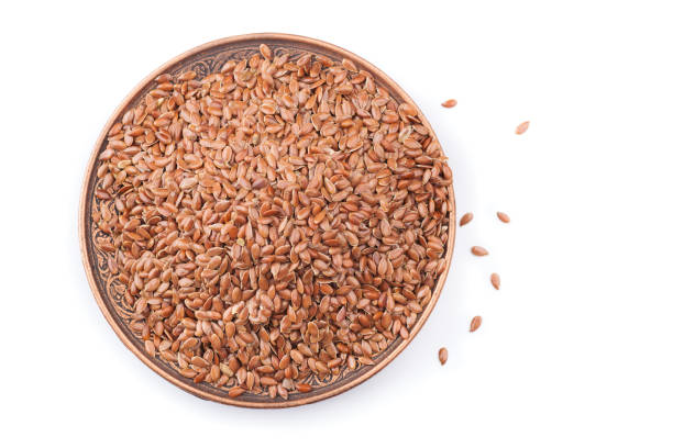 istock Wooden bowl with linen seeds isolated on white background 638627498