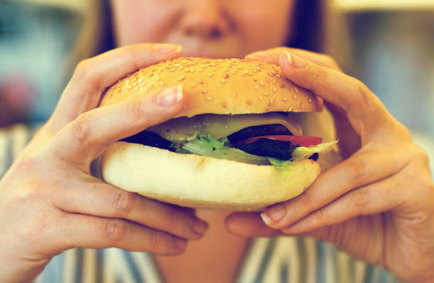 istock Woman hands holding a hamburger. 638631742