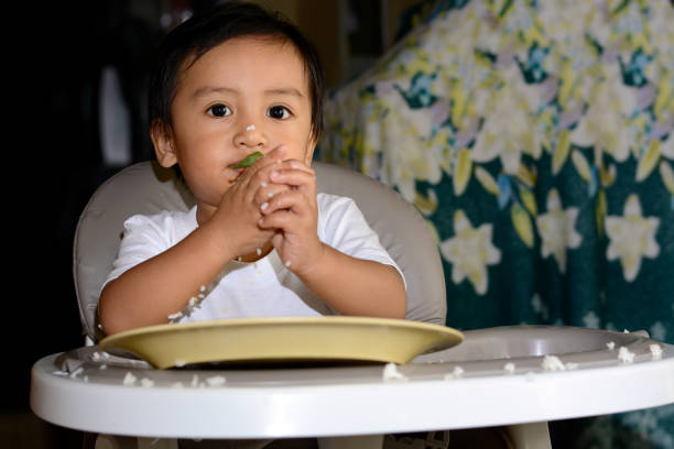 istock One year old baby boy learning to eat by hand 638633832