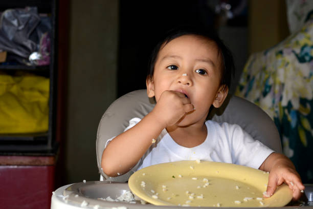 istock One year old baby boy learning to eat by hand 638634030