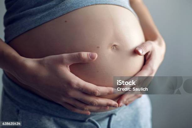 Young Pregnant Girl In A Gray Tshirt And Pants Stock Photo - Download Image Now - Adult, Anticipation, Backgrounds