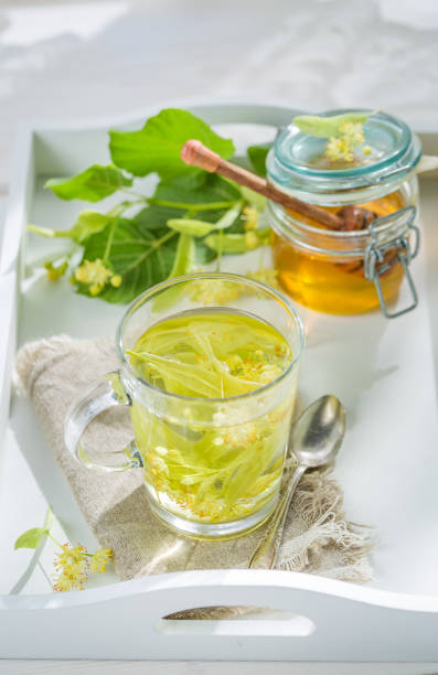 istock Sweet linden tea with honey in spring day 638635472
