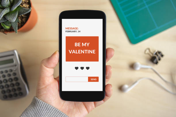 istock Hand holding smart phone with valentine's day concept on screen 638635504