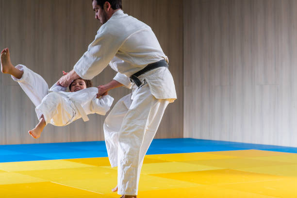 istock Man and young boy are training judo 638635664