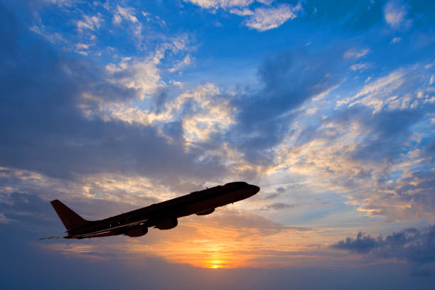istock Silhouette of an airplane taking off, sunset background 638636732