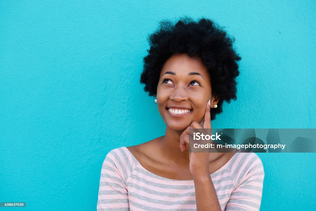 Cute young woman thinking and looking up Close up portrait of a cute young woman thinking and looking up Looking Up Stock Photo