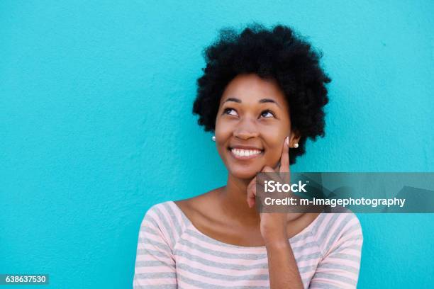 Cute Young Woman Thinking And Looking Up Stock Photo - Download Image Now - Looking Up, Women, Colored Background