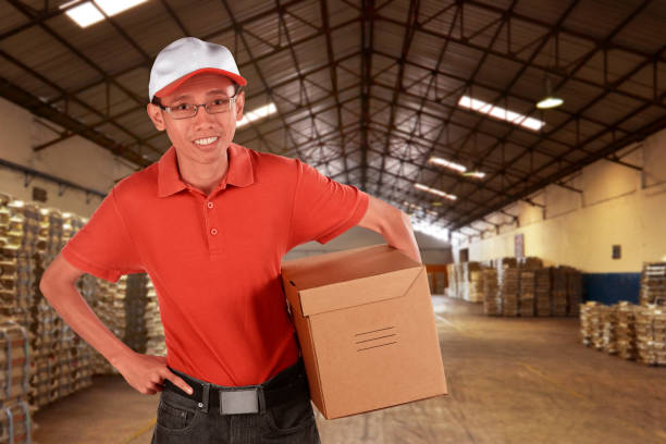 istock Smiling young asian male postal delivery courier 638637564