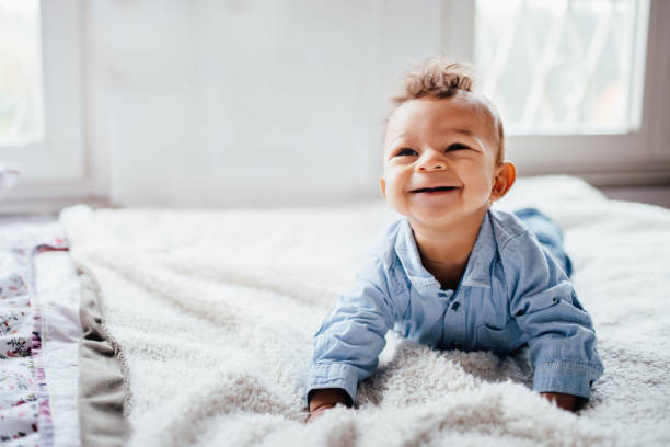 istock Cute adorable toddler smiling while laying on bed 638640072
