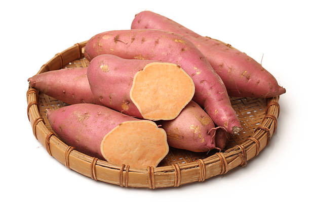 istock Whole and halved sweet potatoes 638642358