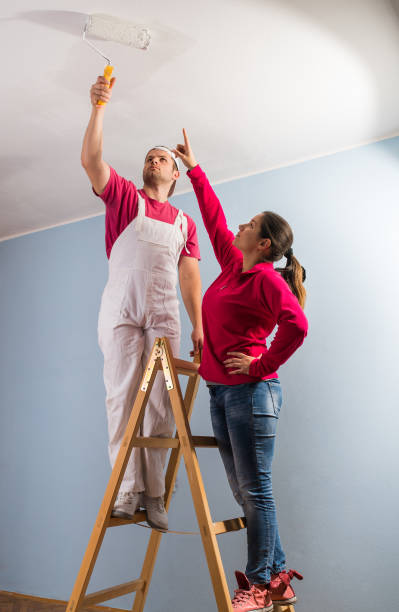 istock Young couple painting wall 638642466