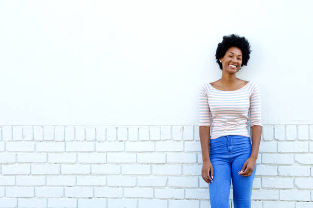 istock Confident happy woman standing by white wall 638642680