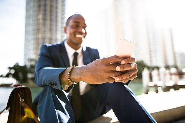 istock businessman texting in miami sitting on the park 638644404