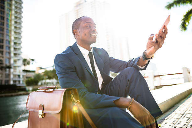 istock businessman texting in miami sitting on the park 638644628