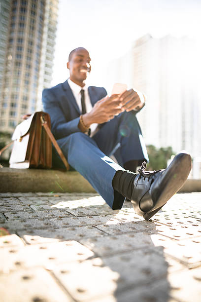 istock businessman texting in miami sitting on the park 638644754