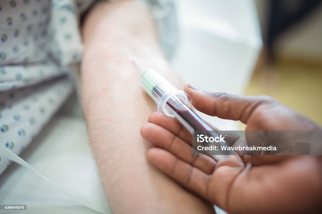 Doctor collecting blood sample from the patient Close-up of doctor collecting blood sample from the patient Blood Test Stock Photo