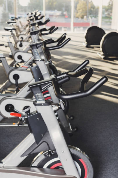 istock Modern gym interior with equipment, fitness exercise bikes handlebars 638648314