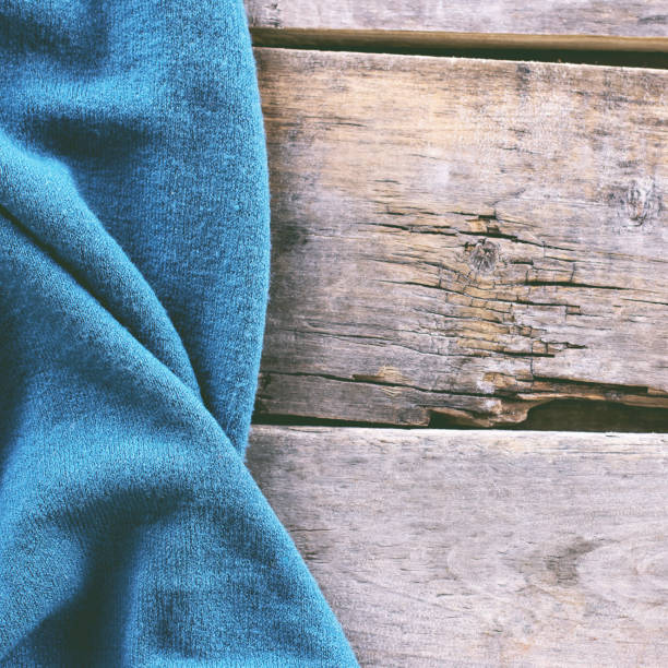 istock knitted plaid, sweater on old wooden boards 638651604