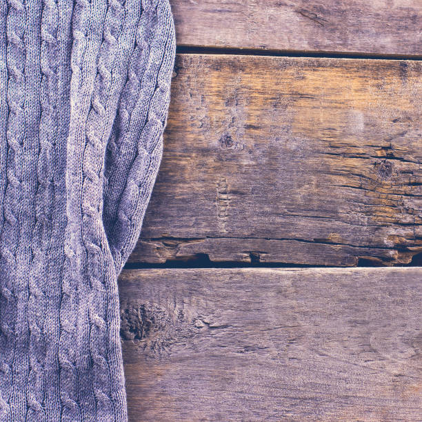 istock knitted plaid, sweater on old wooden boards 638652734